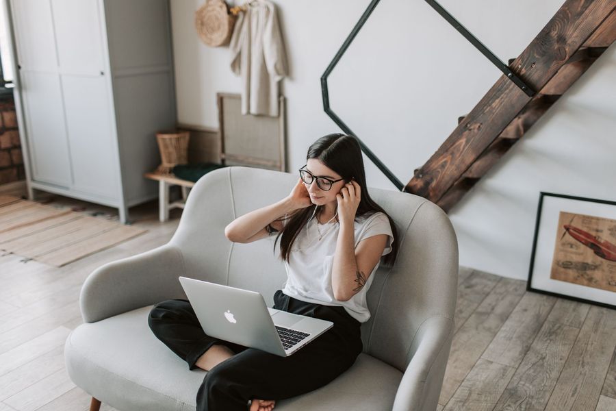 A woman relaxing with a laptop in her apartment