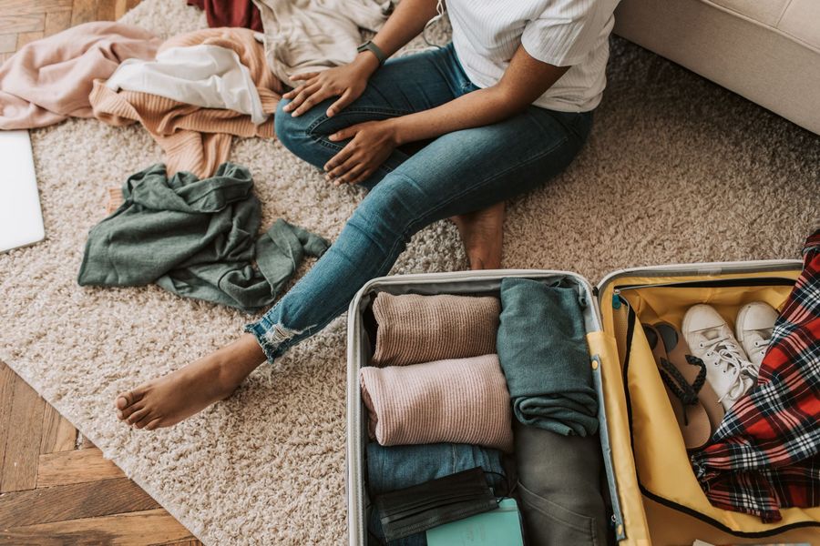A woman packing a suitcase for a trip
